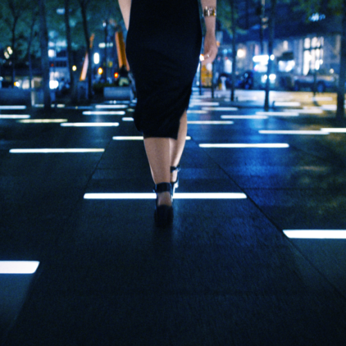 alex-youth-video-frame-rachel-walking-across-light-tiles