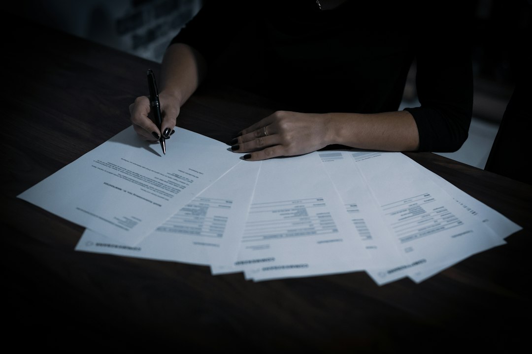 Person signing documents, illustrating music royalty accounting and contract disputes
