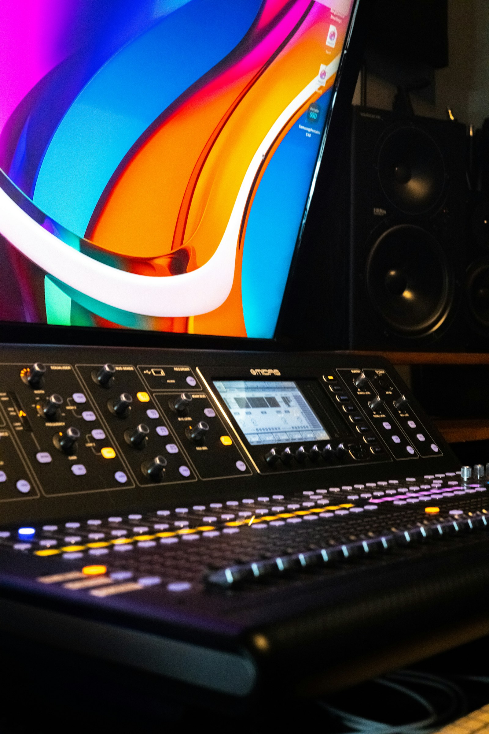 Professional music production console with a computer monitor, representing technology and music-industry data