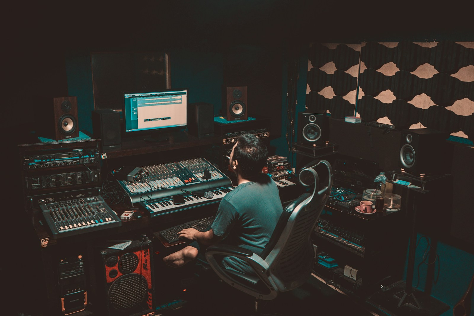 A music producer working at a recording studio desk